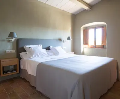 Cama o camas de una habitación en Apartamentos en la Rectoria de Regencós