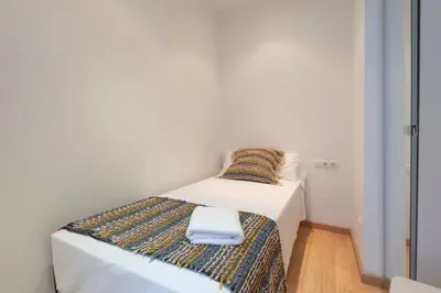 Cama o camas de una habitación en Bravissimo Plaça dels Raïms