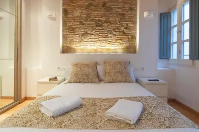 Cama o camas de una habitación en Bravissimo Plaça dels Raïms