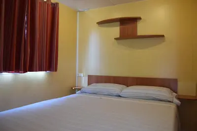 Cama o camas de una habitación en El Carlitos
