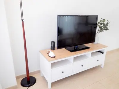 Una televisión o centro de entretenimiento en VILLAS COSETTE - Apartamento Santamaria