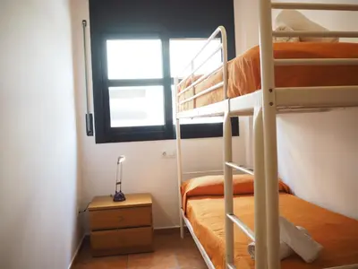 Litera o literas de una habitación en NINFA Apartamento con balcón ideal familias con vistas al mar