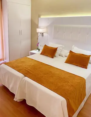 Cama o camas de una habitación en Apartamentos Beverly