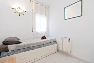 Cama o camas de una habitación en Hauzify I Apartament Orquídies