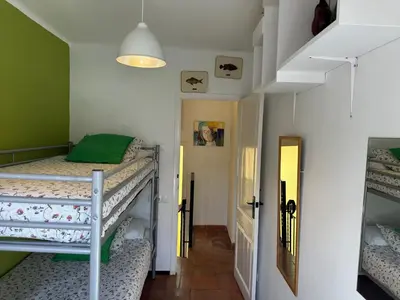 Cama o camas de una habitación en Casa con jardín a 25 metros de la playa. LA T.