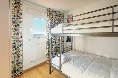 Cama o camas de una habitación en APARTAMENT PAU CASALS, 2 min walk from the sea & sea view