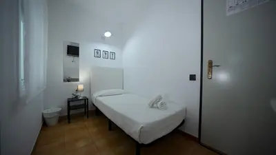 Cama o camas de una habitación en Hostal La Premsa
