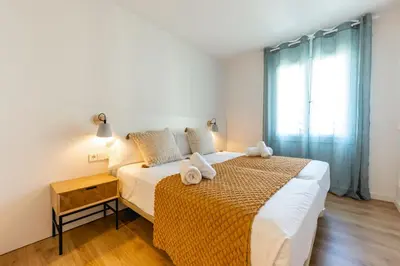 Cama o camas de una habitación en Bravissimo Tarlà, 2-bedroom apartment