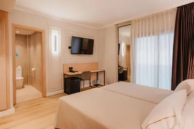 Cama o camas de una habitación en Hotel Miramar