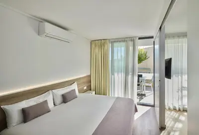 Cama o camas de una habitación en Aparthotel Comtat Sant Jordi