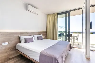 Cama o camas de una habitación en Aparthotel Comtat Sant Jordi