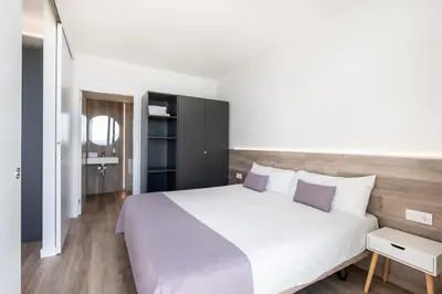 Cama o camas de una habitación en Aparthotel Comtat Sant Jordi
