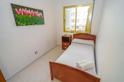 Cama o camas de una habitación en HomeHolidaysRentals Cyan- Costa Barcelona