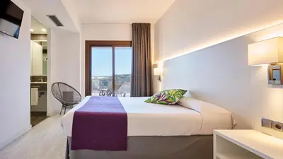 Cama o camas de una habitación en Hotel Samba